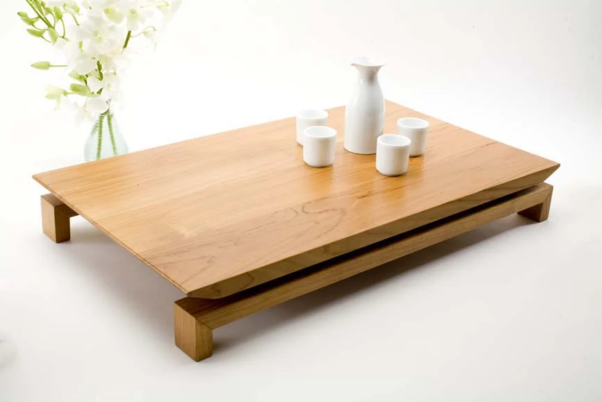 Handcrafted timber hospitality serving tray with white ceramic sake set and floral arrangement